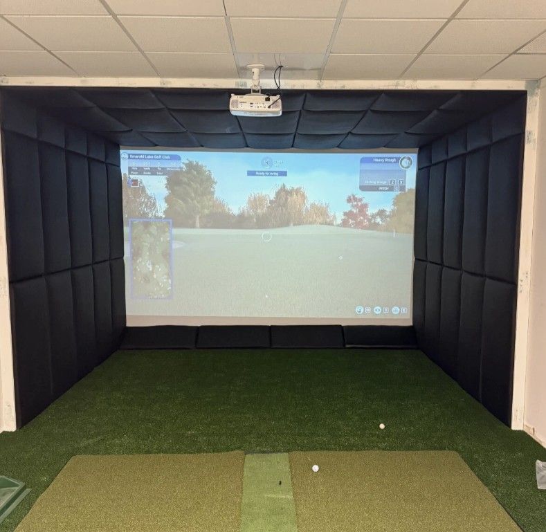 Golf simulator in action showing Emerald Lake Golf Club on the impact screen